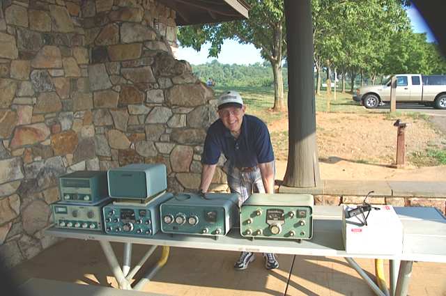 Jim Owen K4CGY and estate sale table of radios